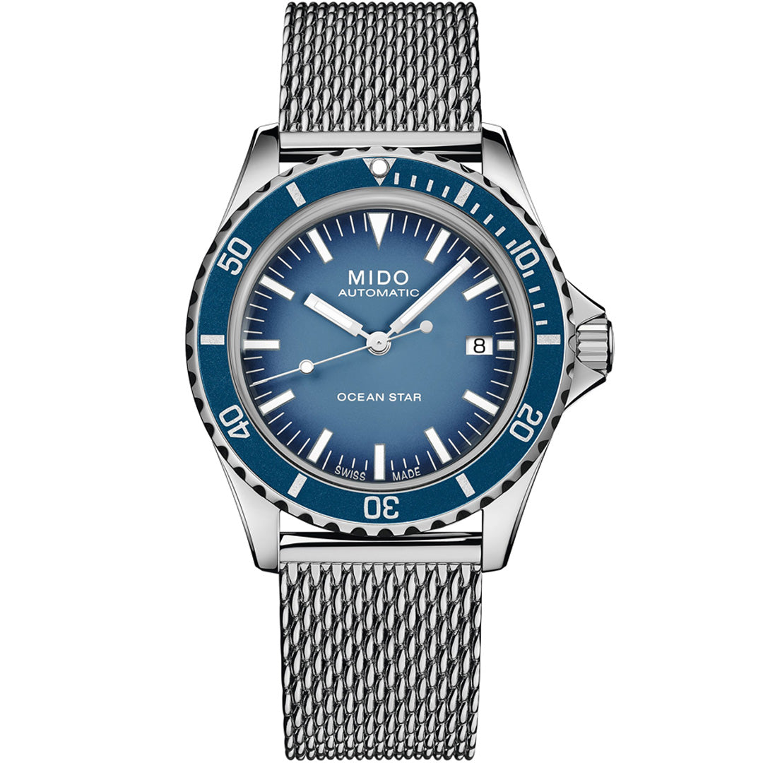 The MIDO Ocean Star Tribute Automatic 40.5mm Watch features a blue dial, silver hands, date at 3 o’clock, blue bezel, and silver mesh bracelet—a sleek, modern Swiss watch ideal for diving fans.