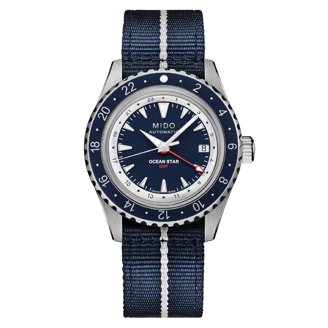 The MIDO Ocean Star Tribute GMT Automatic 40.5mm Watch features a blue and silver bezel, blue dial, date at 3 o’clock, and a blue fabric strap with white center stripe.