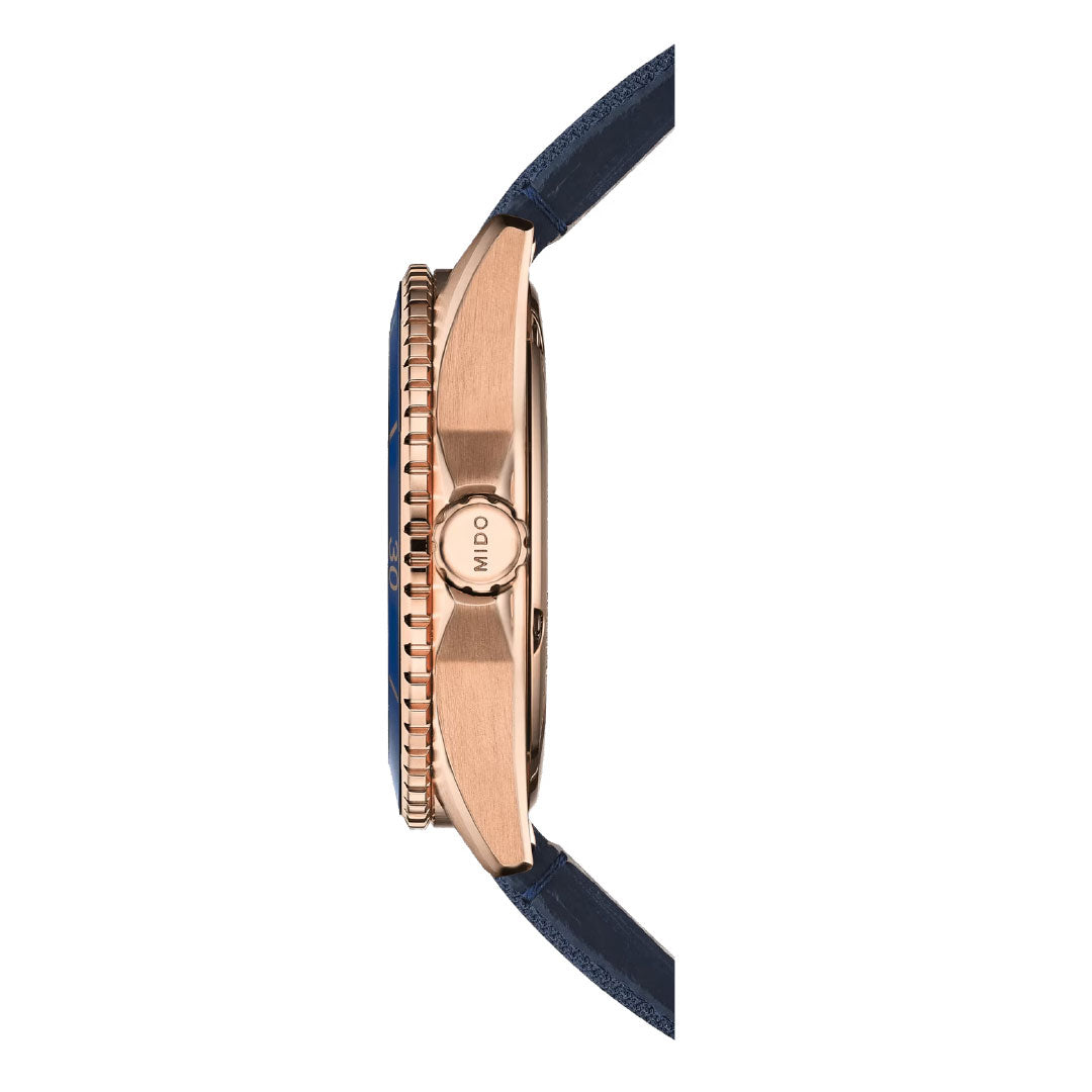 Side view of the MIDO Ocean Star 39mm Automatic watch featuring a rose gold case, blue bezel, blue leather strap, and "MIDO" engraved crown. This water-resistant MIDO timepiece is displayed against a white background.