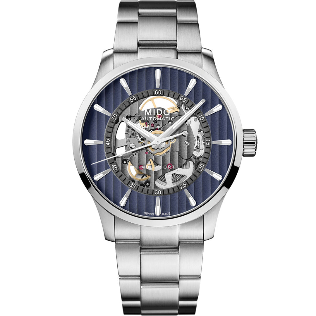 The MIDO Multifort Skeleton Vertigo Automatic 42mm Watch features a metal band, blue striped dial, and exposed gears, highlighting Swiss craftsmanship through its intricate skeleton design.