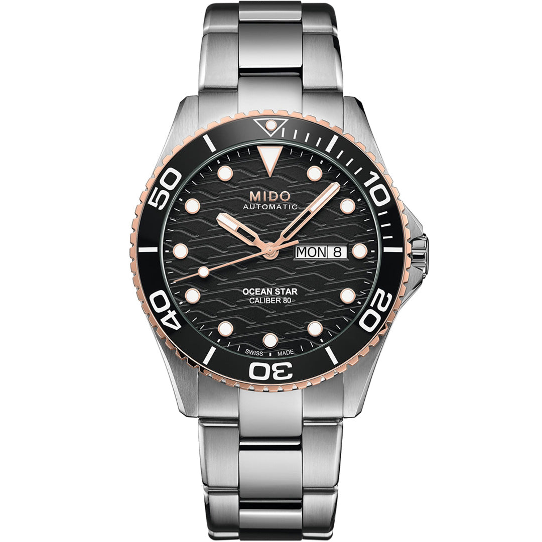The MIDO Ocean Star 200C Automatic 42.5mm Watch features a stainless steel case, black wave-pattern dial with luminous markers, day/date display, and a black & rose gold rotating bezel. This Swiss diving watch is water-resistant.
