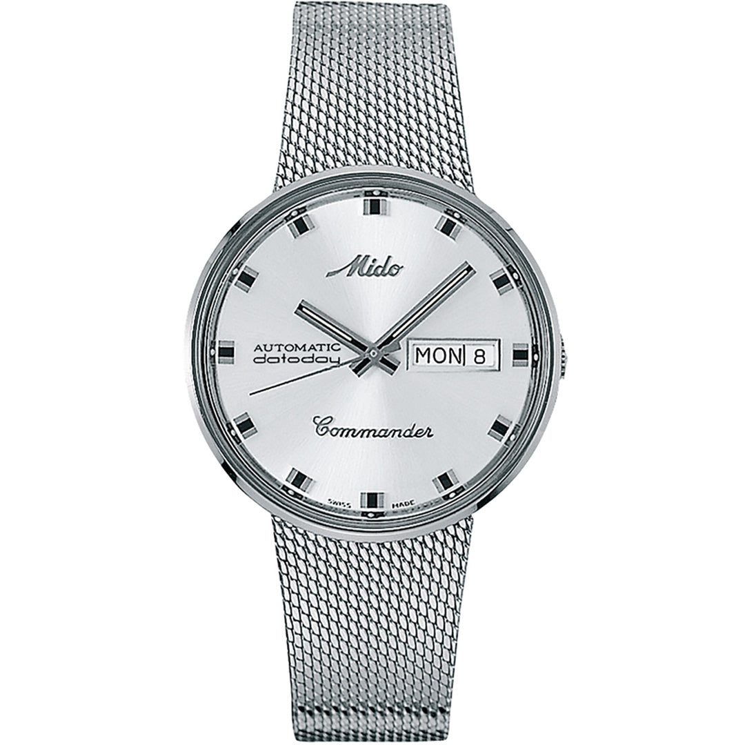 The MIDO Commander 1959 Automatic 37mm Watch features a silver dial, black hour markers and hands, day-date display on the right, automatic movement, and a silver mesh integrated bracelet.