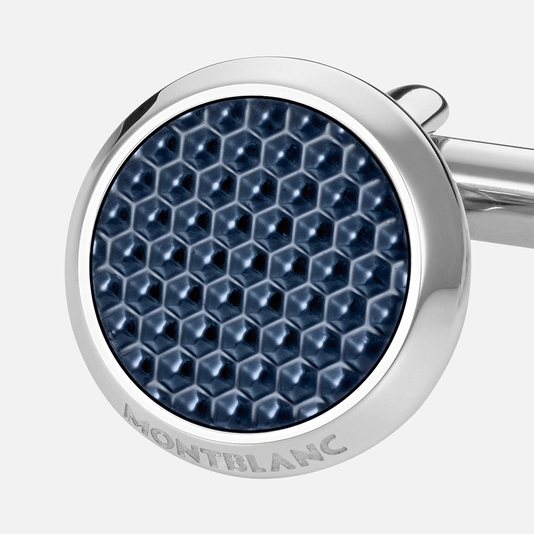 A close-up of Montblanc Meisterstück Stainless Steel Cufflinks showcases a polished round design with a textured dark blue hexagonal center and "MONTBLANC" engraved on the edge—an elegant accessory for any collection.