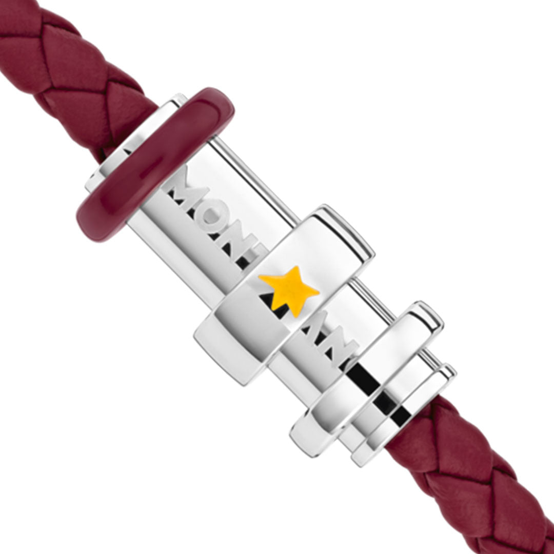 A detailed view of the clasp from the Montblanc Le Petite Prince Y3 Leather and Steel Bracelet, showcasing the silver closure with a yellow star motif, secured to a bracelet made of intricately braided red woven leather.