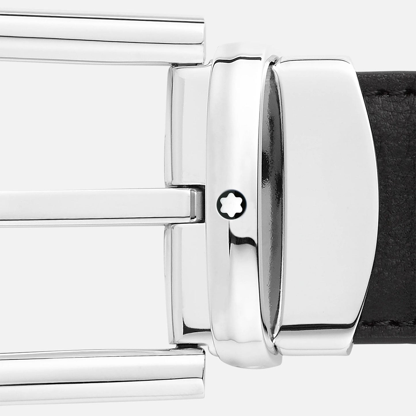Close-up of the sophisticated Montblanc Horseshoe Leather Belt featuring a reversible leather strap. Its silver-toned buckle, embellished with a star-shaped emblem, showcases a palladium finish that enhances the elegance of the design against a plain, light background.