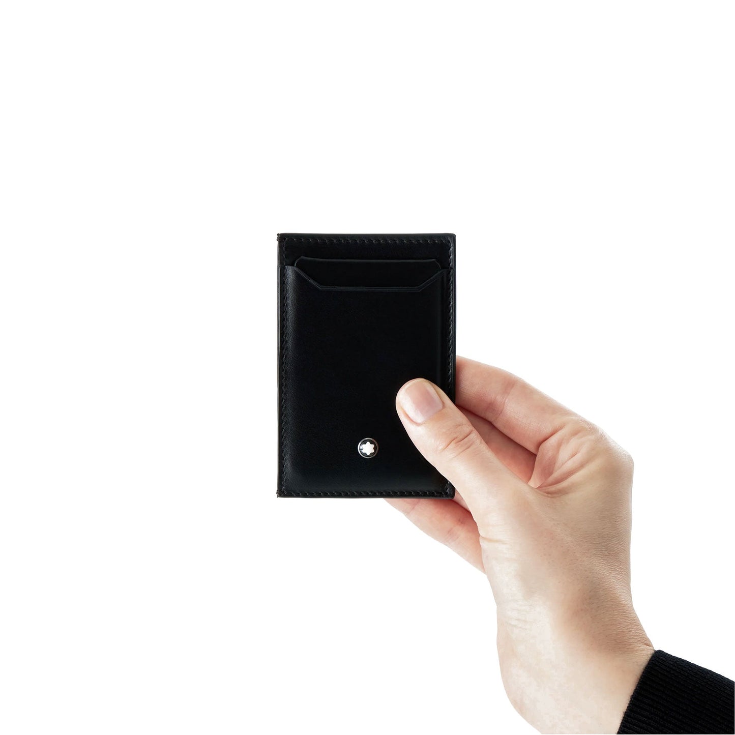 A hand holding a sleek Montblanc Meisterstück Black Leather Pocket 3CC Card Holder against a plain white background. This elegant accessory, resembling a stylish black pocket essential, features a stitched border with the signature Montblanc emblem tastefully placed near the bottom.