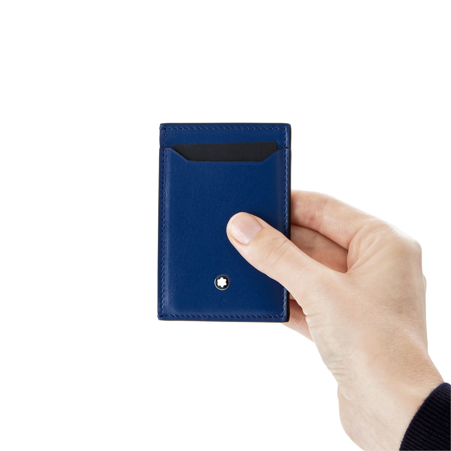A hand holding a Montblanc Meisterstück Blue Leather Pocket 3CC Card Holder, adorned with a small metallic logo at the bottom. The Montblanc card holder features a visible card slot and is set against a plain white background.