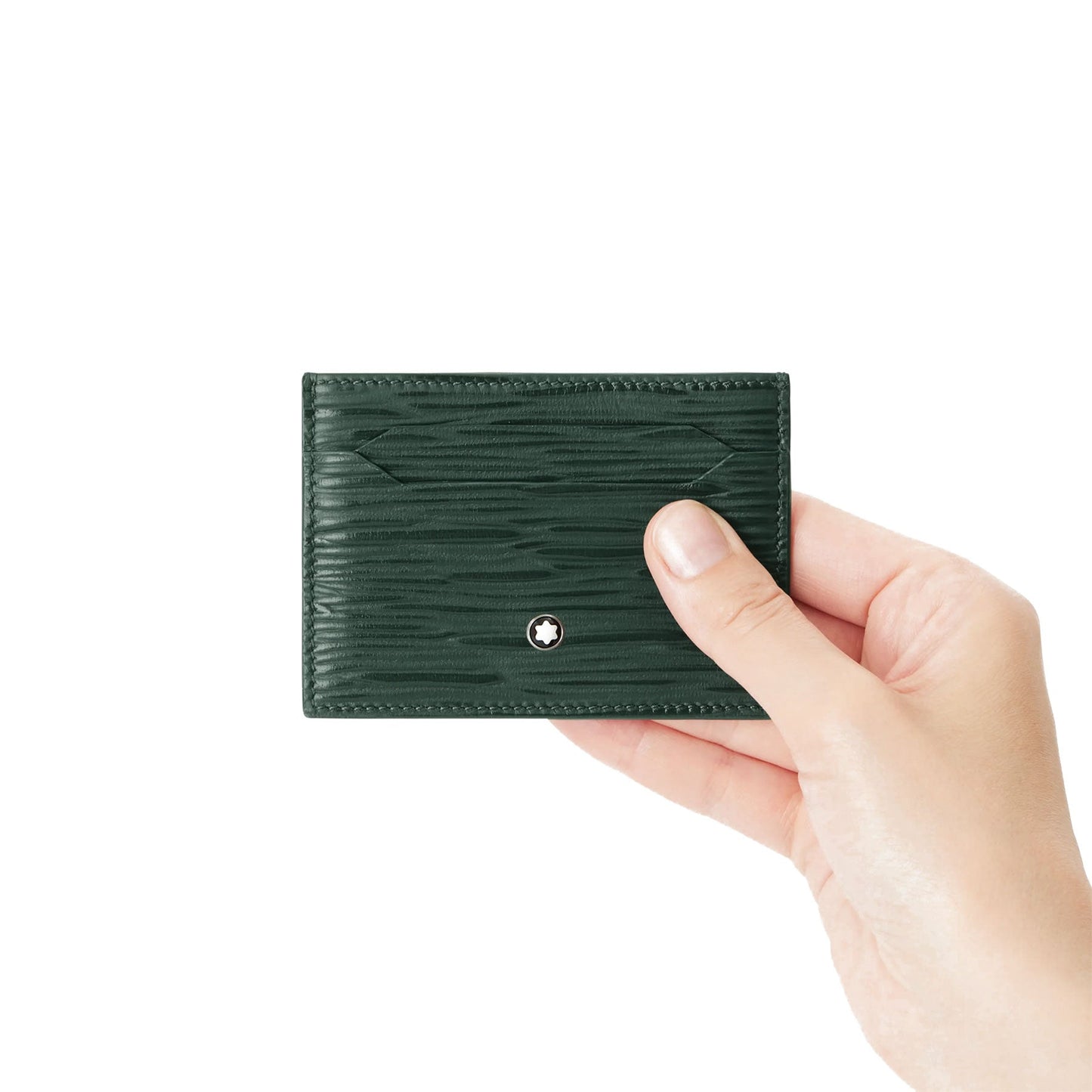 A hand holding a Montblanc Meisterstuck 4810 5cc British Green Leather Card Holder against a plain white background. The high-quality leather features subtle stitching details and a small metallic emblem at the center, exuding an aura of understated luxury.