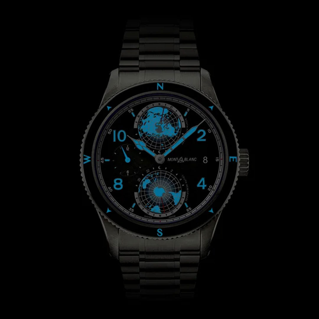 The Montblanc 1858 Geosphere 0 Oxygen The 8000 Automatic 42mm Watch is showcased, featuring a sleek black design with a dark metal band. Its face displays blue-glowing numerals and world maps, emphasizing the compass points at 3, 6, 9, and 12. This wristwatch embodies a distinctive Montblanc style with a Manufacture Worldtime complication housed in a robust titanium case.