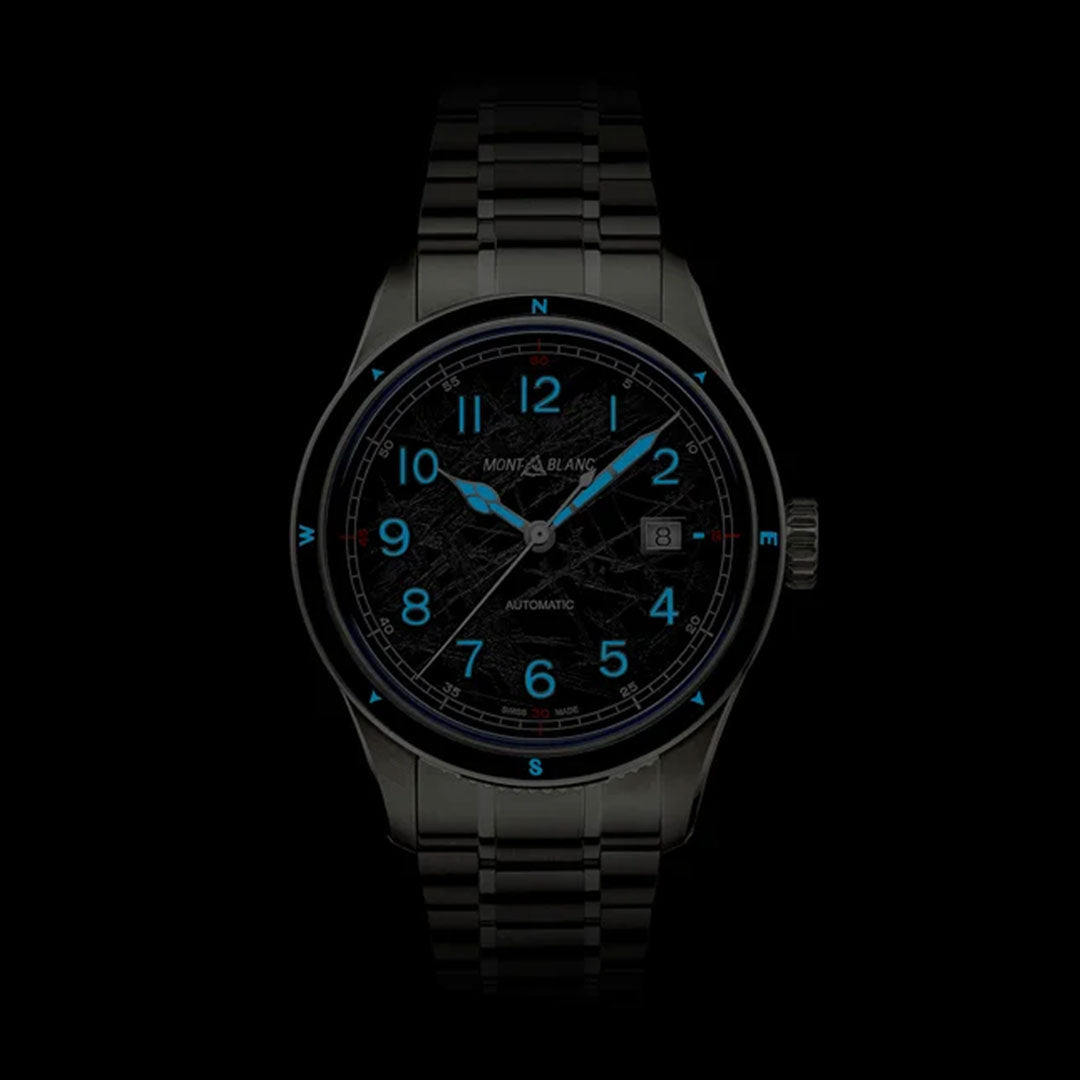 Introducing the Montblanc 1858 Date 0 Oxygen The 8000 Automatic 41mm Watch, a sophisticated timepiece with a metal band. This model features a striking black dial adorned with glowing blue numerals and compass indicators. The elegant three hands are skillfully set against the dark background, complementing its Automatic Date function.