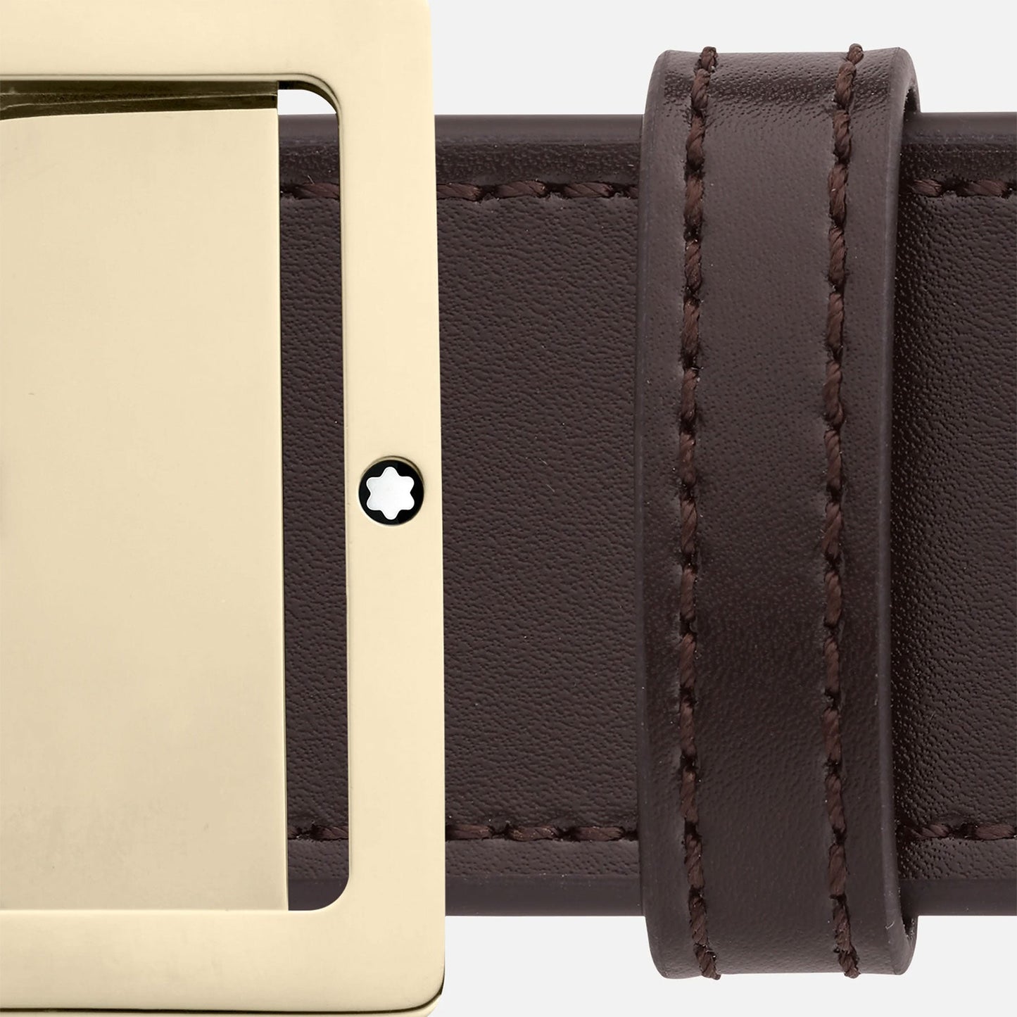 Close-up of the Montblanc Reversible 40mm Black/Brown Leather Belt, showcasing its dark brown finish and polished rectangular gold buckle. The belt is adorned with detailed stitching along the edges and features a small star-like Montblanc logo near the buckle, enhancing its elegant design.
