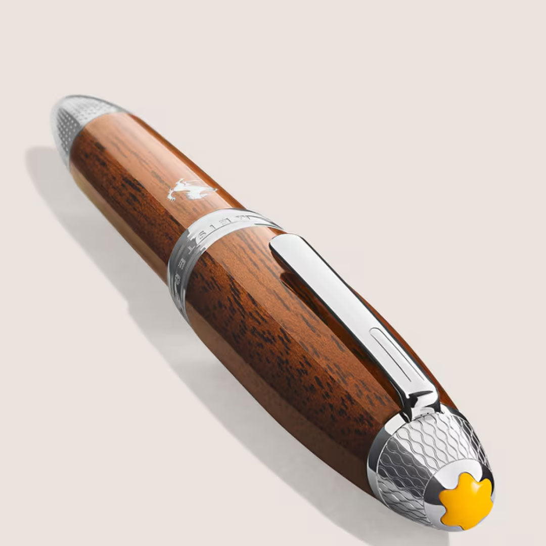 The Montblanc Meisterstück Great Masters Ferrari Tailor Made Classica Special Edition Fountain Pen features a polished brown wood barrel, silver accents, and a yellow emblem on the cap, displayed on a light background.