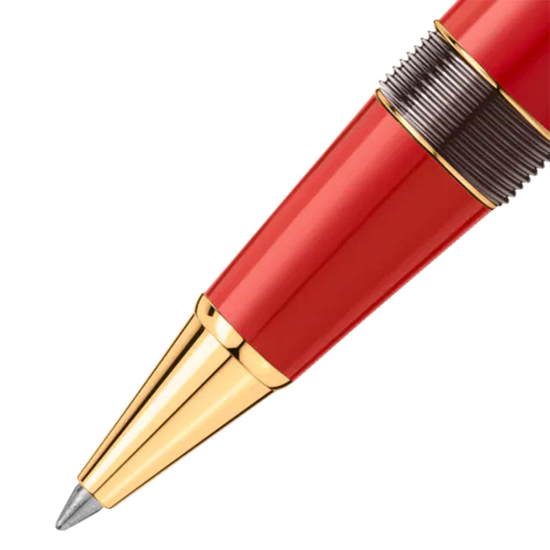 Close-up of the Montblanc Meisterstück x Olympic Heritage Paris 1924 LeGrand Rollerball, showcasing its sleek design. This special edition pen features a smooth red barrel, a gold tip, and a metallic ridged section near the nib, echoing the elegance celebrated since the Olympic Games Paris 1924.