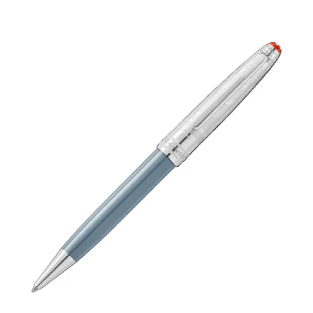 A sleek Montblanc Meisterstück x Olympic Heritage Chamonix 1924 Doué Classique ballpoint pen with a light blue barrel and shiny silver cap and tip, resting against a plain white background. The pen, reminiscent of the Meisterstück centenary style, features a small red accent on the cap.