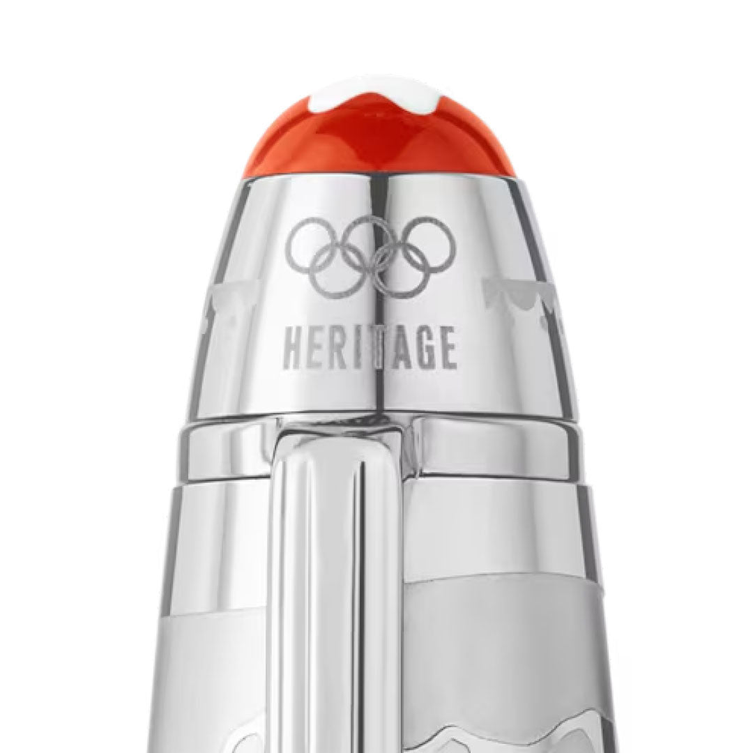 A detailed view of the Montblanc Meisterstück x Olympic Heritage Chamonix 1924 Solitaire LeGrand Rollerball reveals its elegant silver finish, adorned with the Olympic rings and "Heritage" intricately engraved on its body. The pen is topped with a striking red accent, evoking the spirit of the 1924 Chamonix Olympic Games.