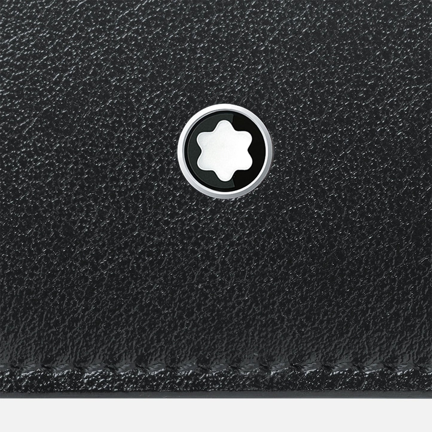 Close-up of the Montblanc Meisterstück 4CC Black Leather Card Holder, showcasing its textured black leather finish and a circular Montblanc emblem adorned with a white six-pointed star in the center, ideal for organizing your business cards.