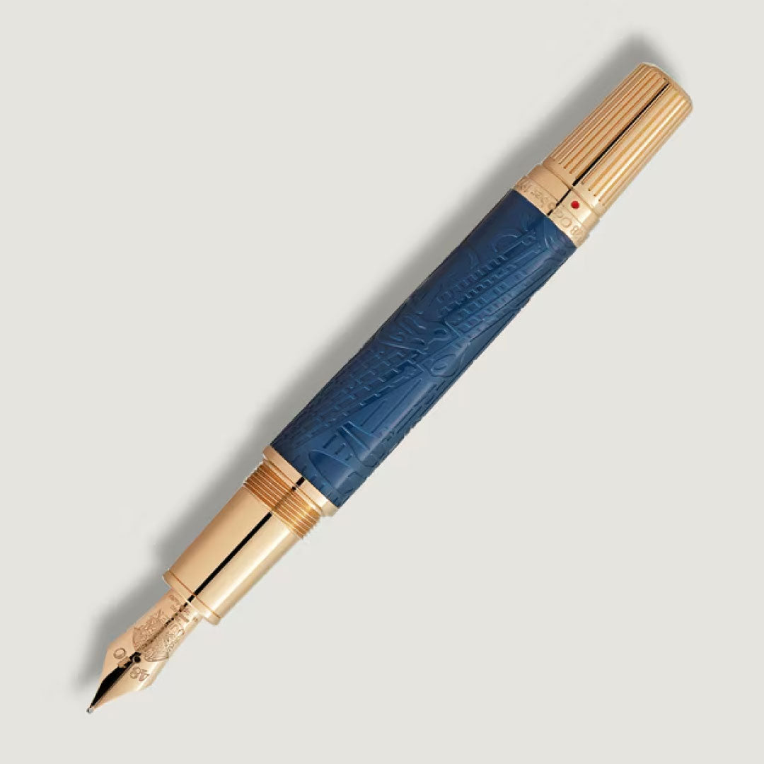 The Montblanc Pen Great Characters Homage to Queen Special Edition Fountain Pen features a textured blue barrel, gold accents, nib and cap, all from Montblanc, shown against a light neutral background.