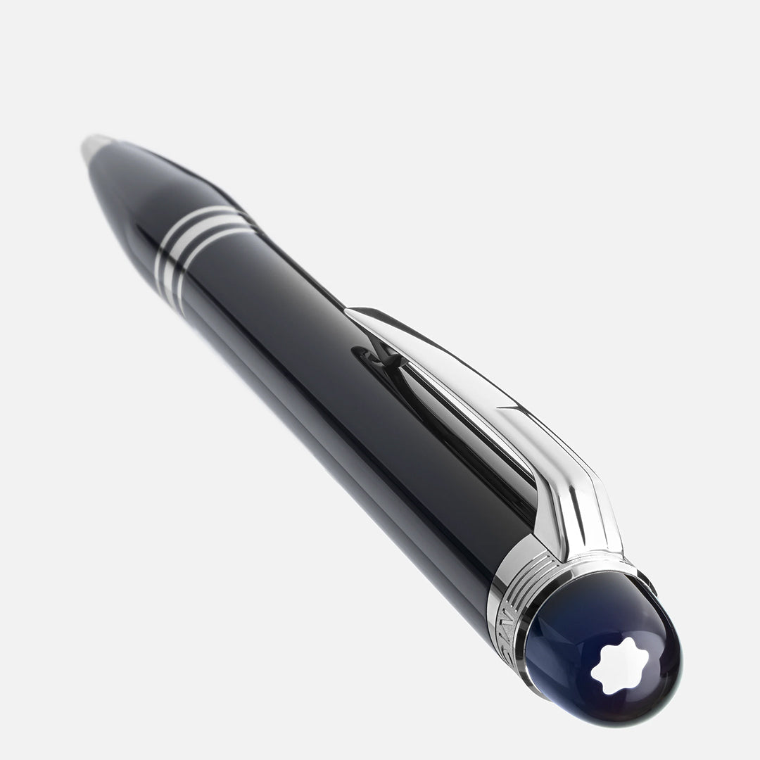 The Montblanc Starwalker Precious Resin Ballpoint Pen boasts sleek black design, silver highlights, and a side clip. A Montblanc emblem graces its cap. The pen rests diagonally on a white background, embodying space exploration inspiration.