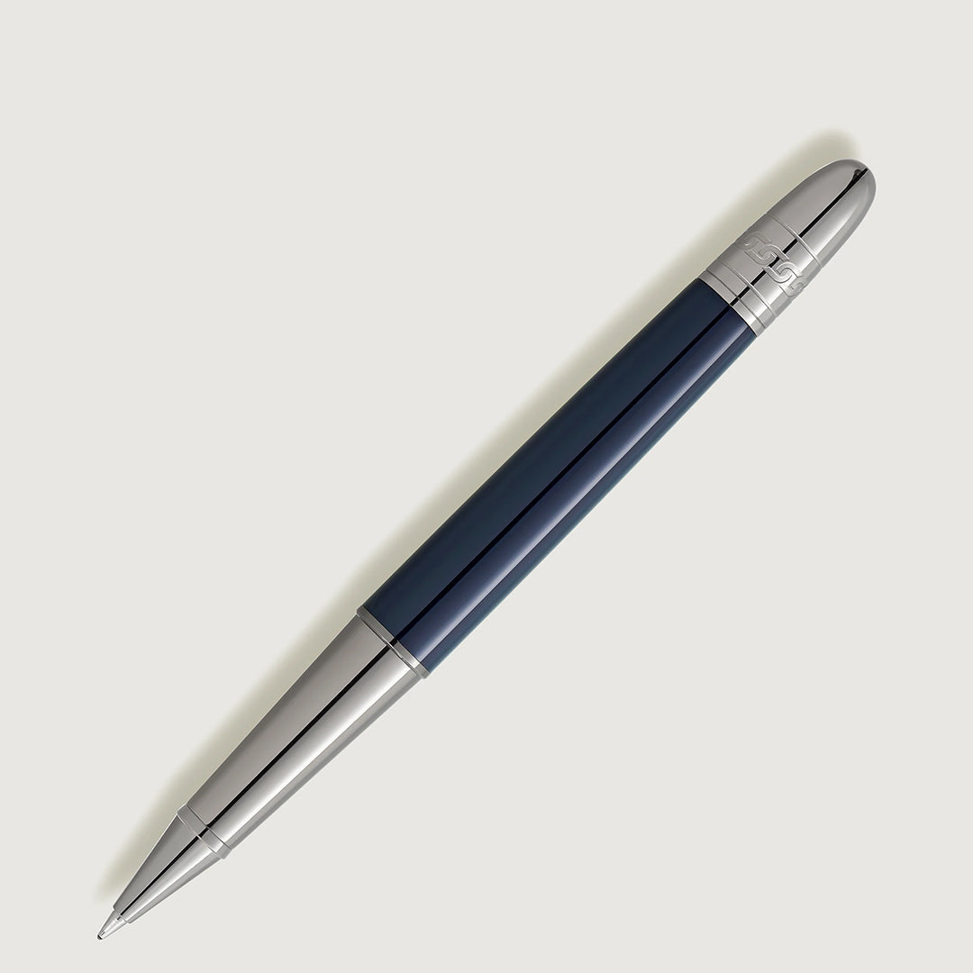 The Montblanc Meisterstuck Around the World in 80 Days Doue Classique Rollerball Pen, featuring a sleek blue and silver design with a metallic tip reminiscent of Jules Verne's adventurous spirit, is positioned diagonally against a light background.