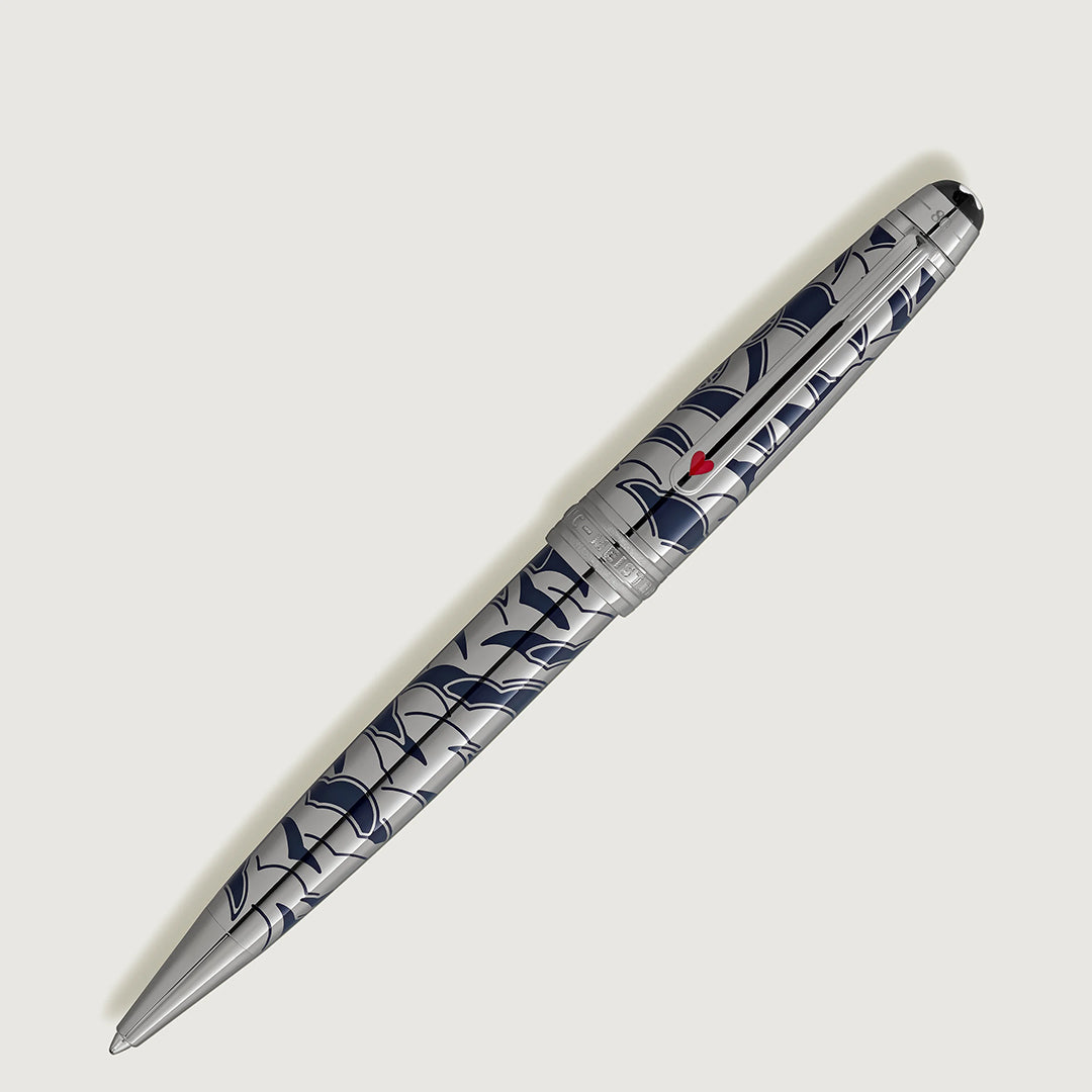 The Montblanc Meisterstuck Around the World in 80 Days Solitaire Midsize Ballpoint Pen features a silver finish with a blue abstract pattern and red detail on the clip, crafted from precious metal and displayed on a plain white background.