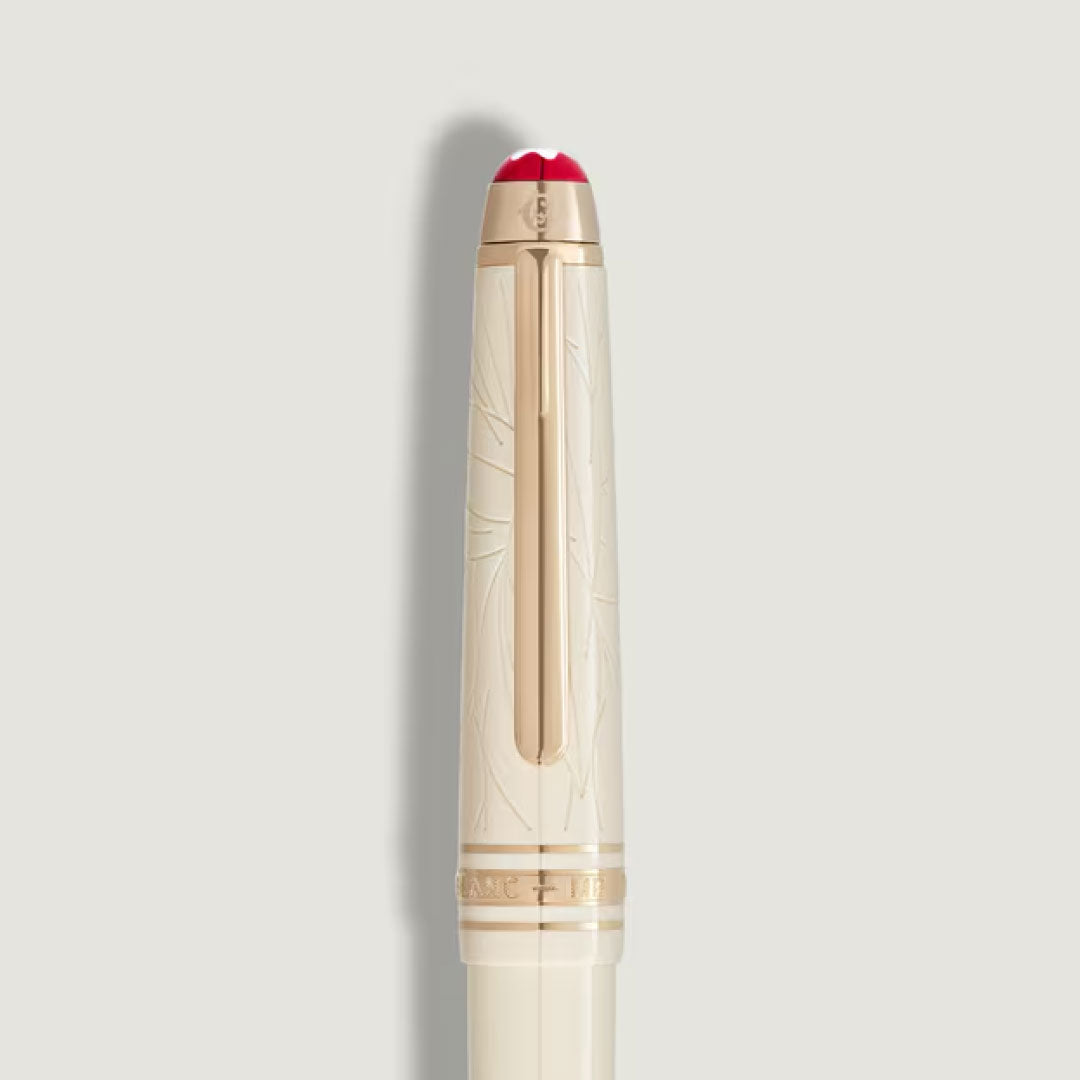 A cream-colored Montblanc Meisterstuck Romeo & Juliet Classique Fountain Pen with gold accents, engraved patterns, and a red-tipped cap is shown against a plain light background.