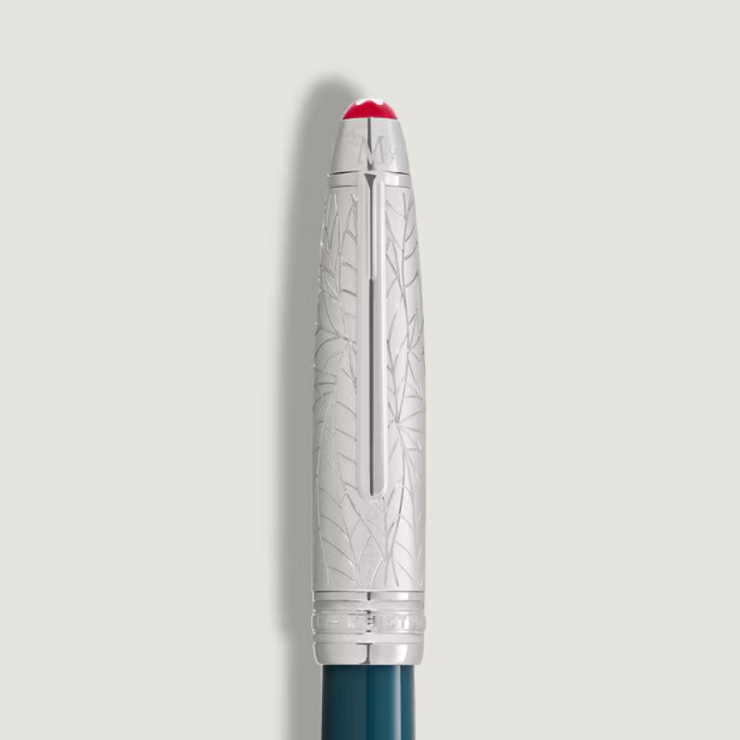 A close-up of the Montblanc Meisterstuck Romeo & Juliet LeGrand Rollerball Pen cap shows engraved leaf patterns, a red tip, and a pocket clip, set against a plain light background.