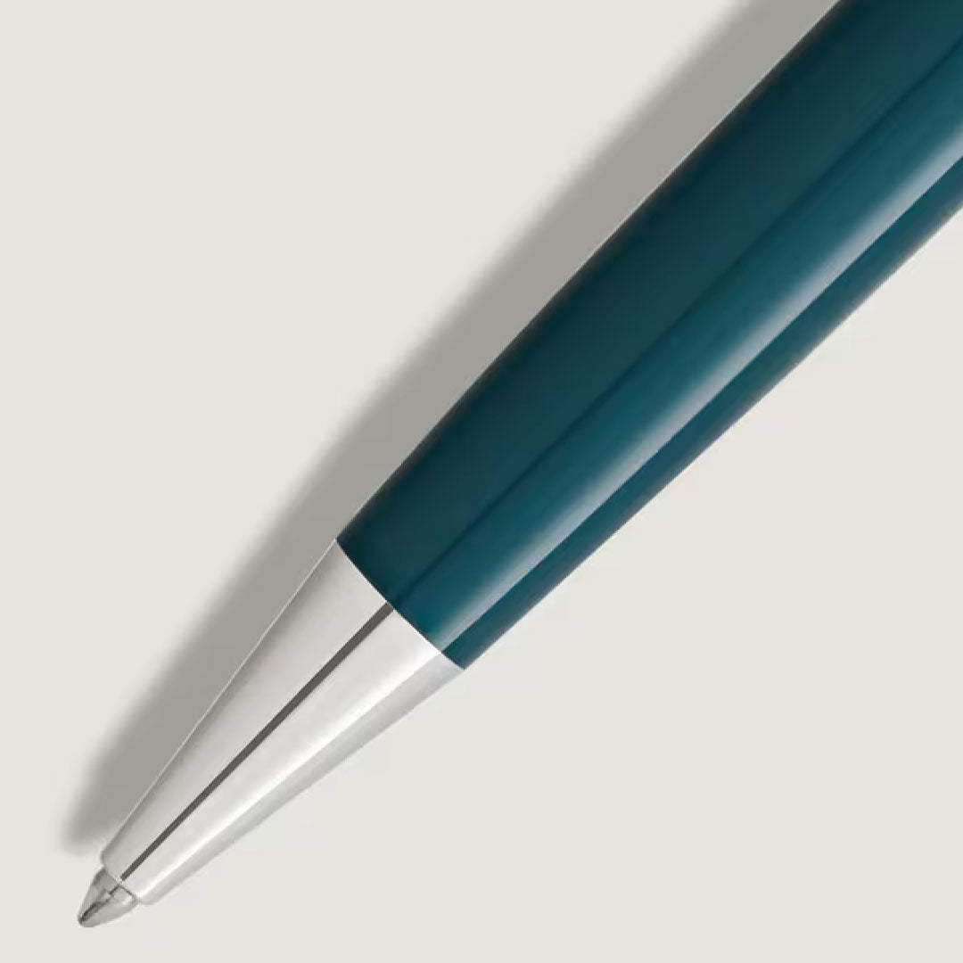 Close-up of the Montblanc Meisterstuck Romeo & Juliet Doue Midsize Classique Ballpoint Pen, featuring a shiny silver tip and a teal precious resin barrel, positioned diagonally on a light gray background.