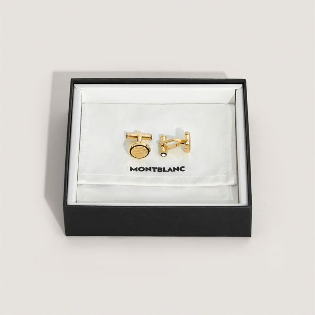 The Montblanc Masters of Art Homage to Gustav Klimt Cufflinks, crafted in gold and echoing the artistic essence of Gustav Klimt, are elegantly presented in an open black and white box. Their design is beautifully highlighted against the soft white fabric lining.