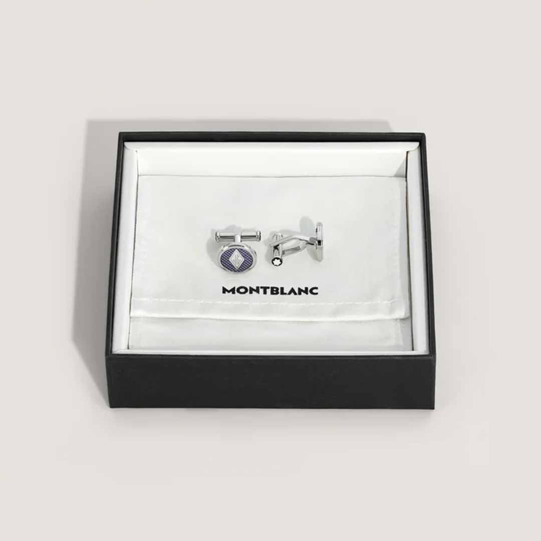 The Montblanc Great Characters Homage to The Great Gatsby Cufflinks, crafted from stainless steel with a circular design, are elegantly presented in an open black box lined with white fabric. The word "Montblanc" is gracefully printed on the fabric inside the box, evoking the opulence of The Great Gatsby.
