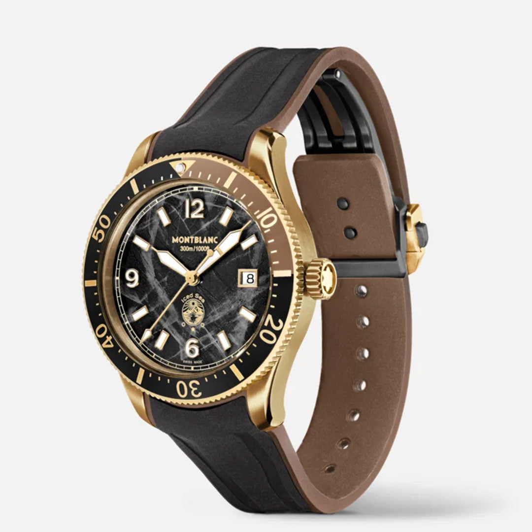 The Montblanc Iced Sea Automatic 41mm Watch showcases a sleek design with its glacier pattern dial and gold-tone bezel. It includes prominent luminous numerals and hands, a date display positioned at 3 o'clock, and is complemented by a black and brown leather strap. The watch is presented to highlight its side profile.