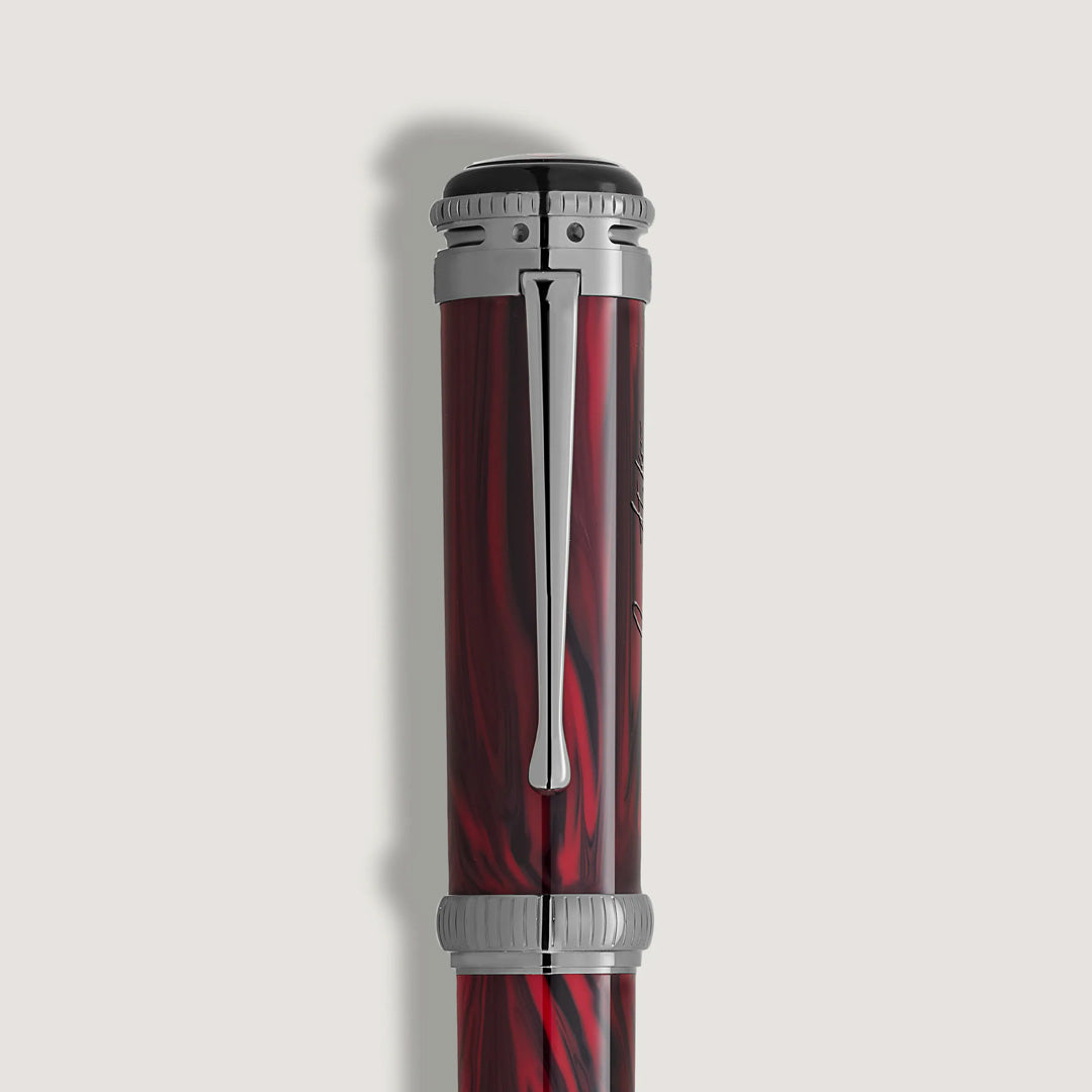 A close-up of the cap of the Montblanc Writers Edition Homage to Bram Stoker Limited Edition Fountain Pen, showing red and black marbling, silver accents, and a clip against a plain white background.