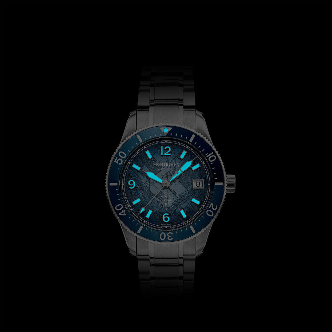 The Montblanc Iced Sea Automatic Date 0 Oxygen 38mm Watch features a metal band, glacier-patterned dial, luminous blue markers and hands, and a date window—all shown against a black background.