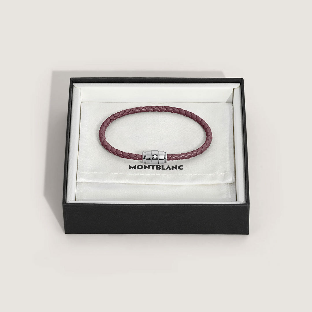 The Montblanc Meisterstuck 3 Rings Cassis Leather Bracelet, crafted from braided calfskin with a silver clasp, is presented in an open black Montblanc box lined with white fabric and displaying the iconic brand emblem.