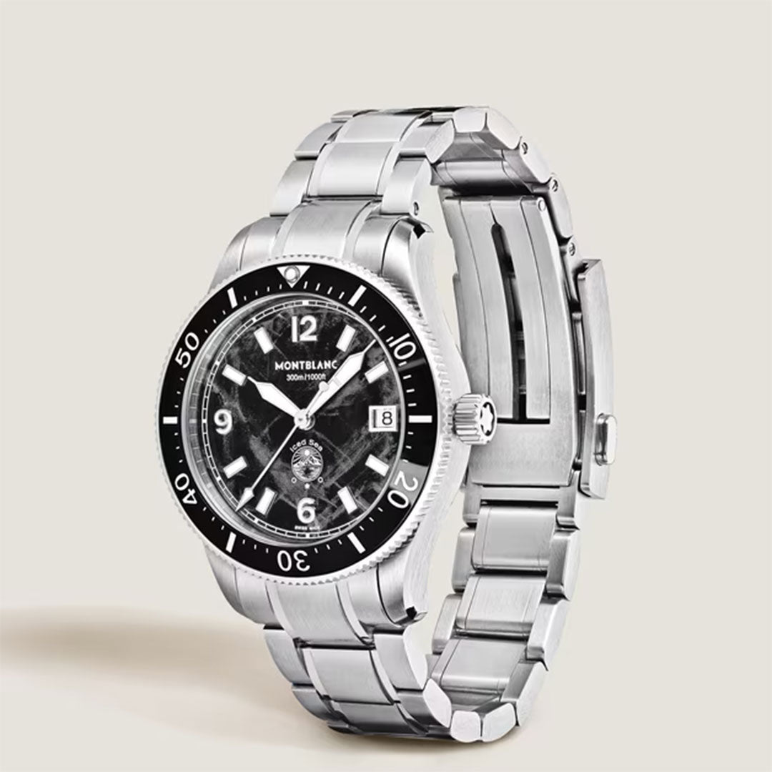 The Montblanc Iced Sea Automatic Date 0 Oxygen 38mm Watch features a black glacier dial, silver hour markers, date display, and rotating bezel. Shown with a stainless steel band at an angle against a light background.