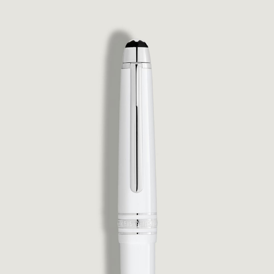 A Montblanc Meisterstuck White Classique Rollerball Pen by Montblanc is displayed vertically with a platinum-coated clip and white details, set against a plain light gray background.