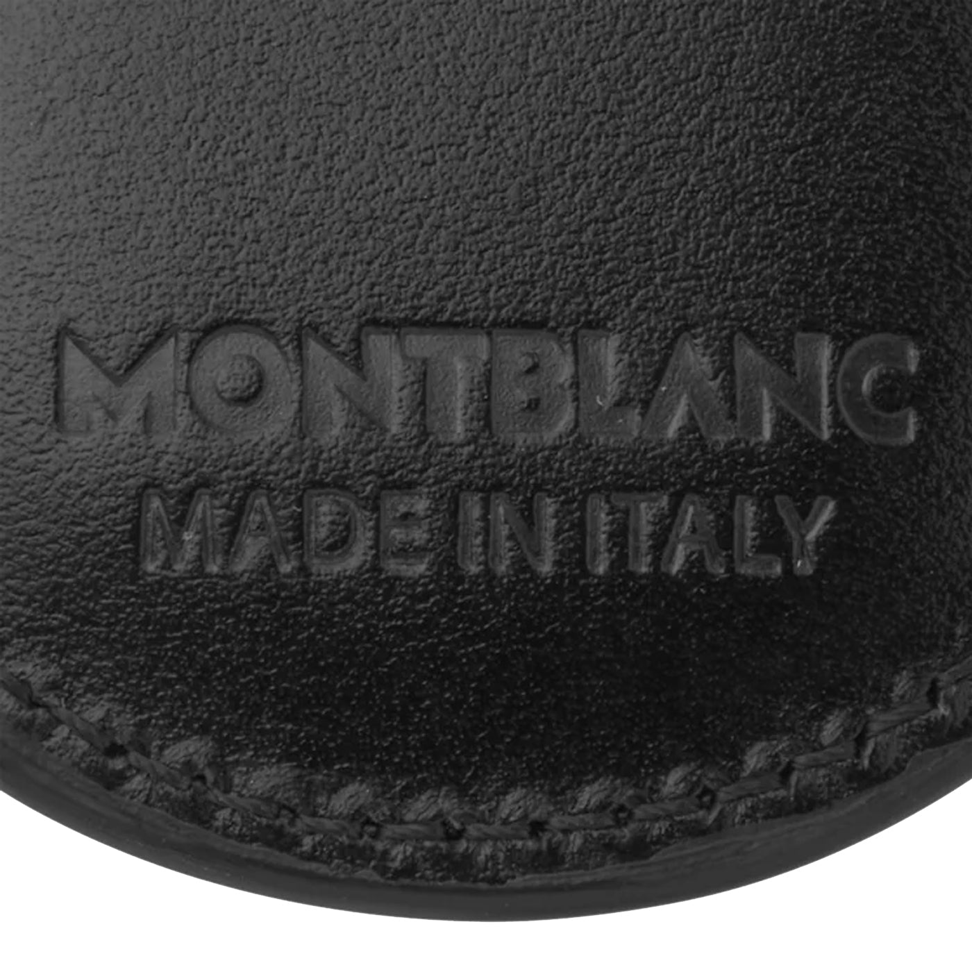 A close-up view of the Montblanc Meisterstück Black Key Ring showcases its exquisite black leather, embossed with "Montblanc Made in Italy." The visible texture is enhanced by meticulous stitching and features a discreet Montblanc emblem.