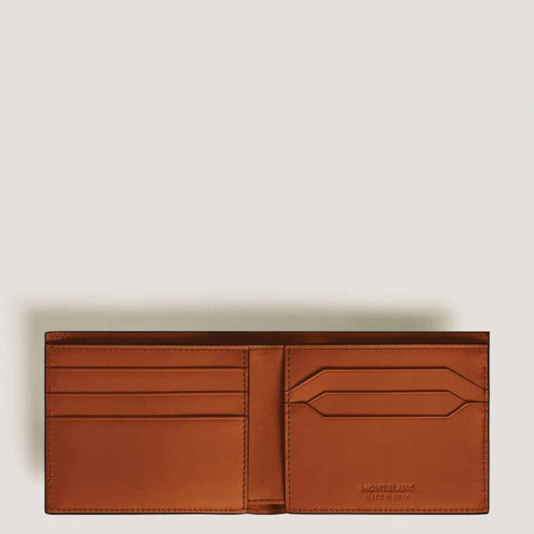A Montblanc Meisterstück 6cc Leather Wallet made from rust-colored leather is open, revealing multiple card slots perfect for credit cards. The embossed text inside enhances its elegance against a simple, light background.