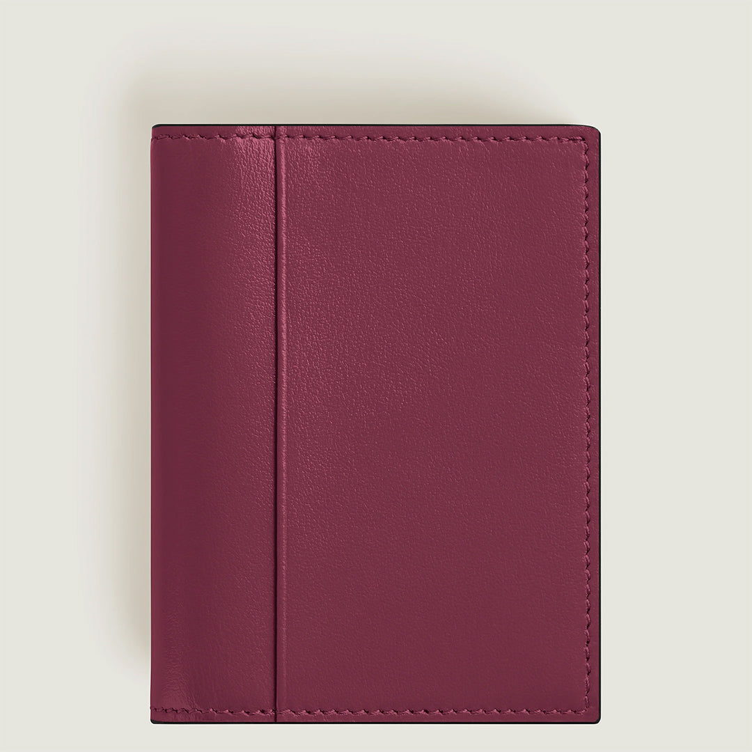The Montblanc Meisterstuck 4CC Card Holder, crafted from maroon leather with clean stitching, is showcased closed on a light gray background. Its sleek design, reminiscent of a sophisticated wallet, makes it ideal for business cards.