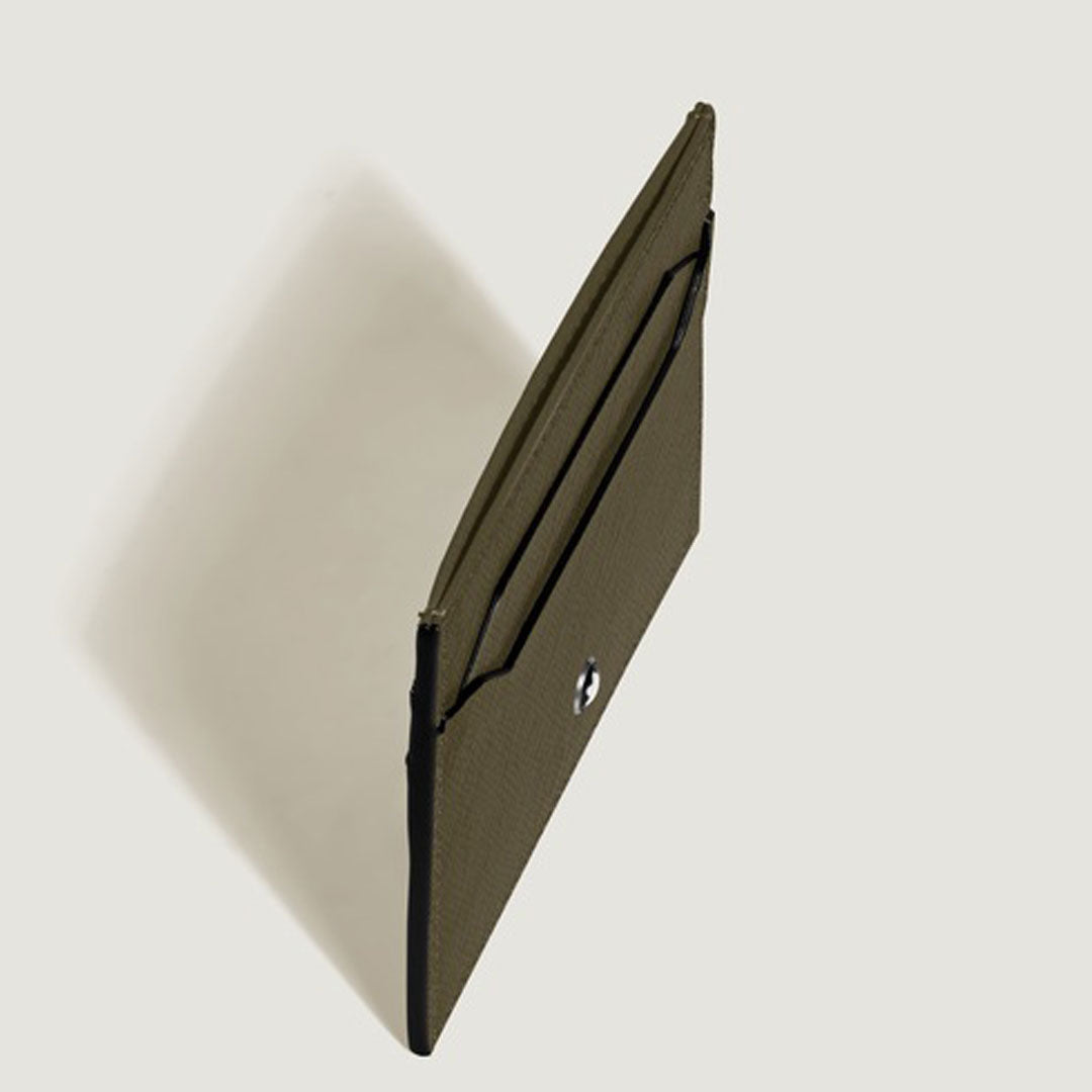The Montblanc Sartorial 6CC Leather Card Holder by Montblanc is a slim, olive green saffiano leather card holder with a snap button closure, shown upright against a light background with its shadow cast to the left.