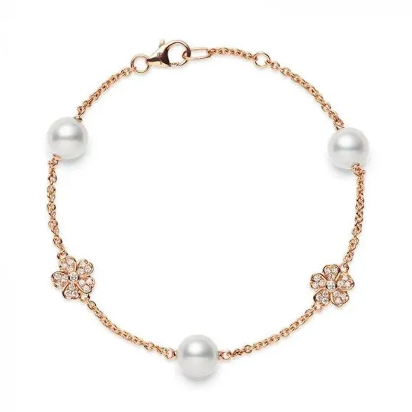 The Mikimoto Cherry Blossom bracelet is crafted from 18K rose gold and showcases two Akoya cultured pearls along with two flower-shaped crystal embellishments, all secured with a lobster clasp.