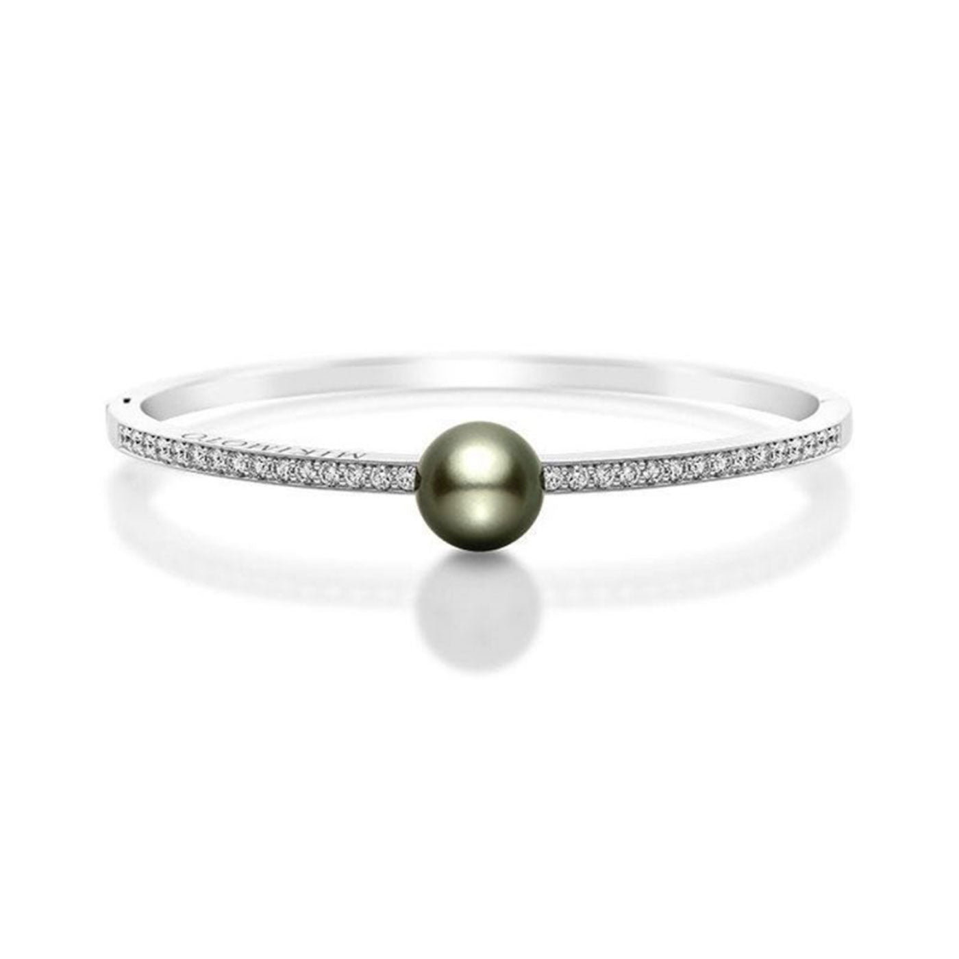 The Mikimoto 18K White Gold Diamond with Black South Sea Pearl Bangle showcases a central Black South Sea pearl, elegantly flanked by rows of dazzling diamonds on each side, epitomizing a minimalist and sophisticated design.