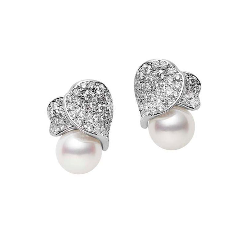 Introducing the Mikimoto 18K White Gold Les Pétales Place Vendôme earrings, where luxurious Akoya cultured pearls are elegantly set beneath exquisite, leaf-shaped designs. These intricate pieces are adorned with sparkling diamonds, reflecting both luxury and craftsmanship from the renowned brand Mikimoto.