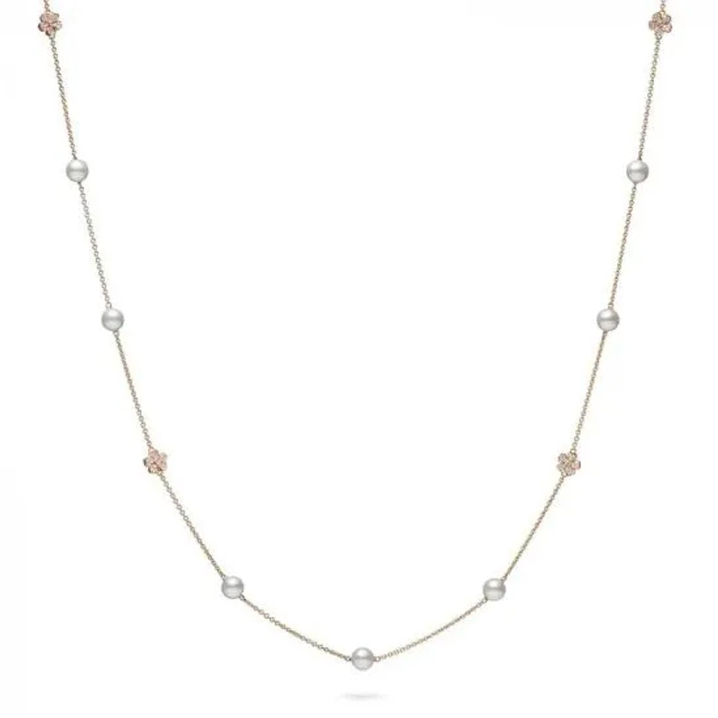 The Mikimoto Cherry Blossom 18K Rose Gold Diamond and Akoya Cultured Pearl Station Necklace showcases a refined design with a slender rose gold chain enhanced by spaced Akoya Cultured Pearls and small rose gold flower details, set against a simple white backdrop.