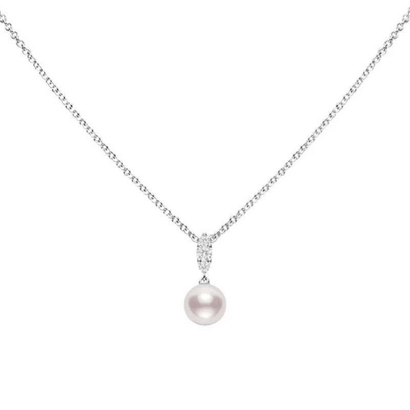 The Mikimoto Morning Dew necklace features an 18K white gold chain with a pendant showcasing an Akoya cultured pearl. It is elegantly attached by a polished loop embellished with tiny, sparkling diamonds, making it a chic addition to any outfit. The plain white background highlights its timeless elegance.