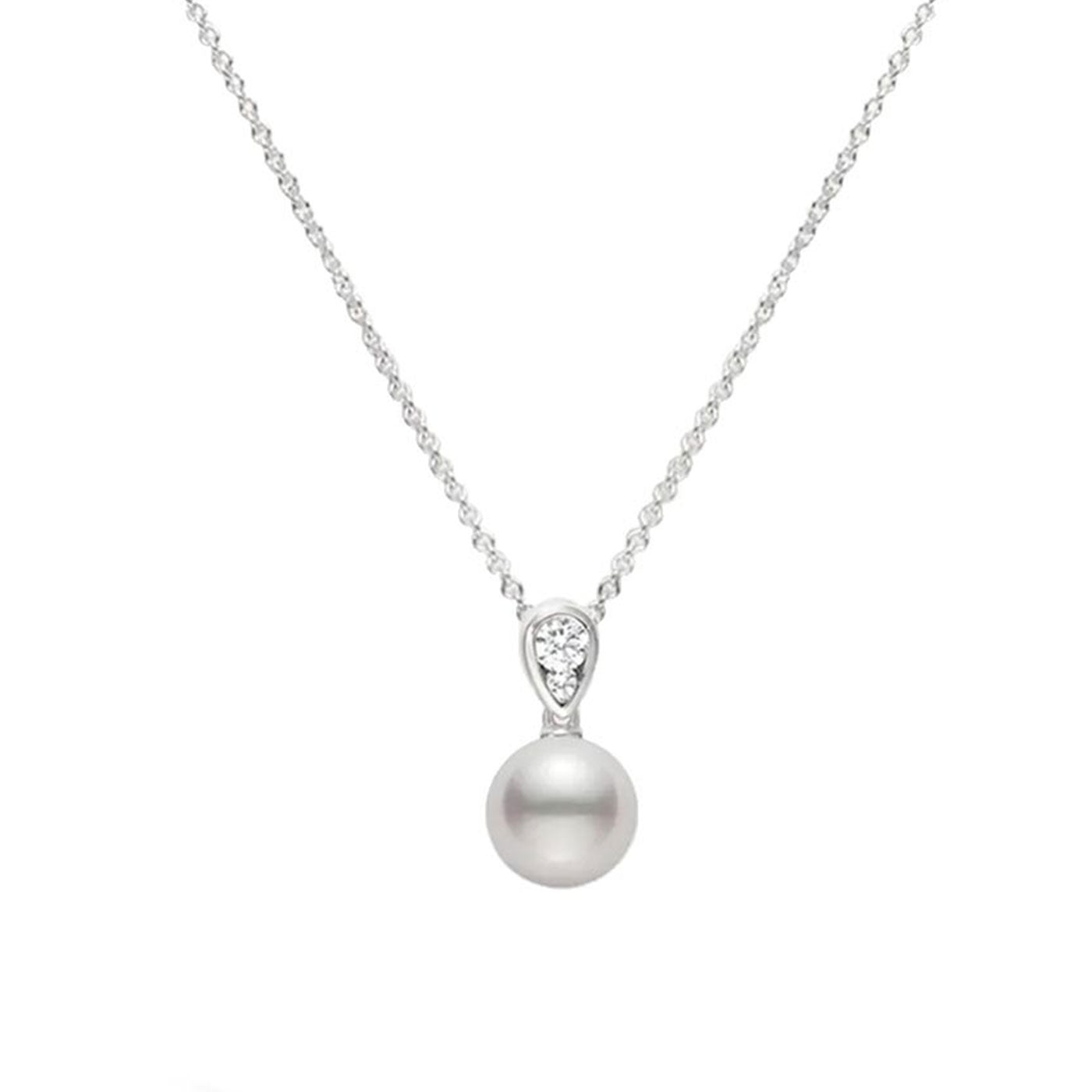 The Mikimoto 18K White Gold Diamond with Akoya Cultured Pearl Necklace Pendant is a masterpiece, featuring a beautiful round pearl suspended from an elegant chain. The 18-karat white gold design includes a delicate teardrop-shaped accent above the pearl, adorned with tiny diamonds that glisten against a plain white backdrop, adding sophistication to any outfit.
