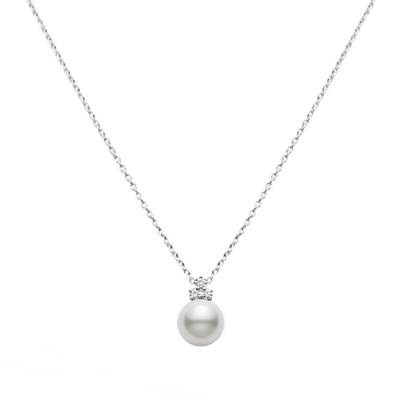 A refined 18K white gold necklace by Mikimoto features a single South Sea Pearl pendant, elegantly adorned with small sparkling diamonds, all set against a simple white background.