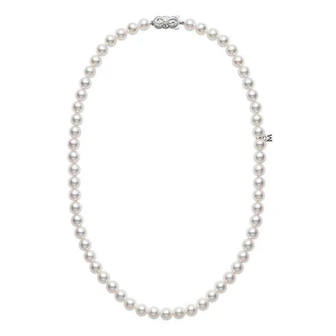 The Mikimoto Akoya Cultured Pearl Strand Necklace features a single strand of round white Akoya cultured pearls, elegantly designed in an 18-inch length with a decorative 18K white gold clasp and a subtle metallic charm on one side.