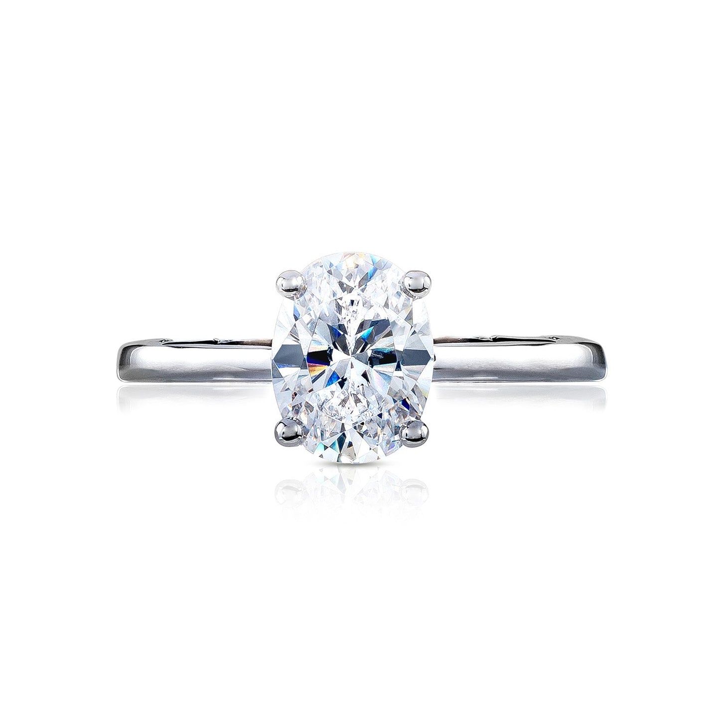 The Tacori Coastal Crescent collection offers a stunning solitaire engagement ring featuring an oval-cut diamond, elegantly set on a refined 14K white gold band with diamond accents.