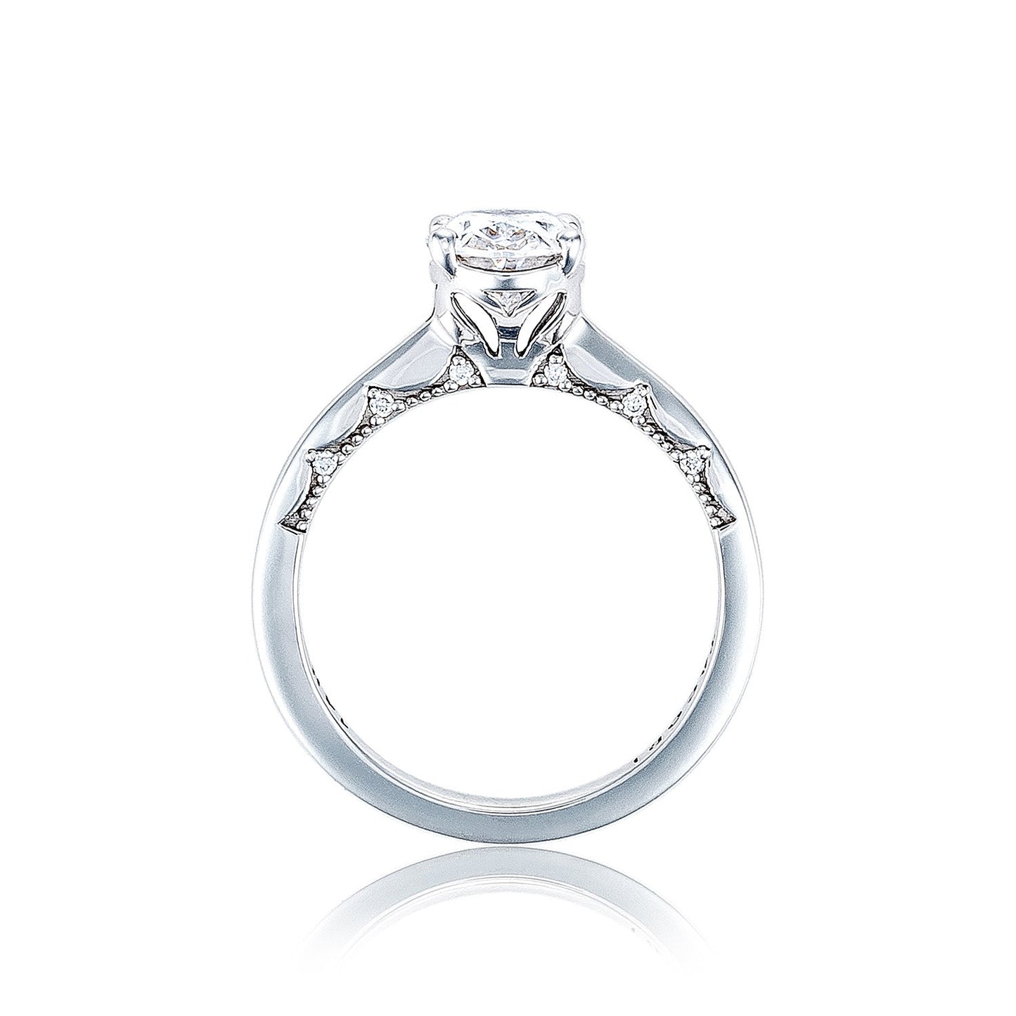 A 14K white gold engagement ring from Tacori's Coastal Crescent collection, showcasing an oval solitaire centerpiece with diamond band accents and intricate detailing along the side profile.