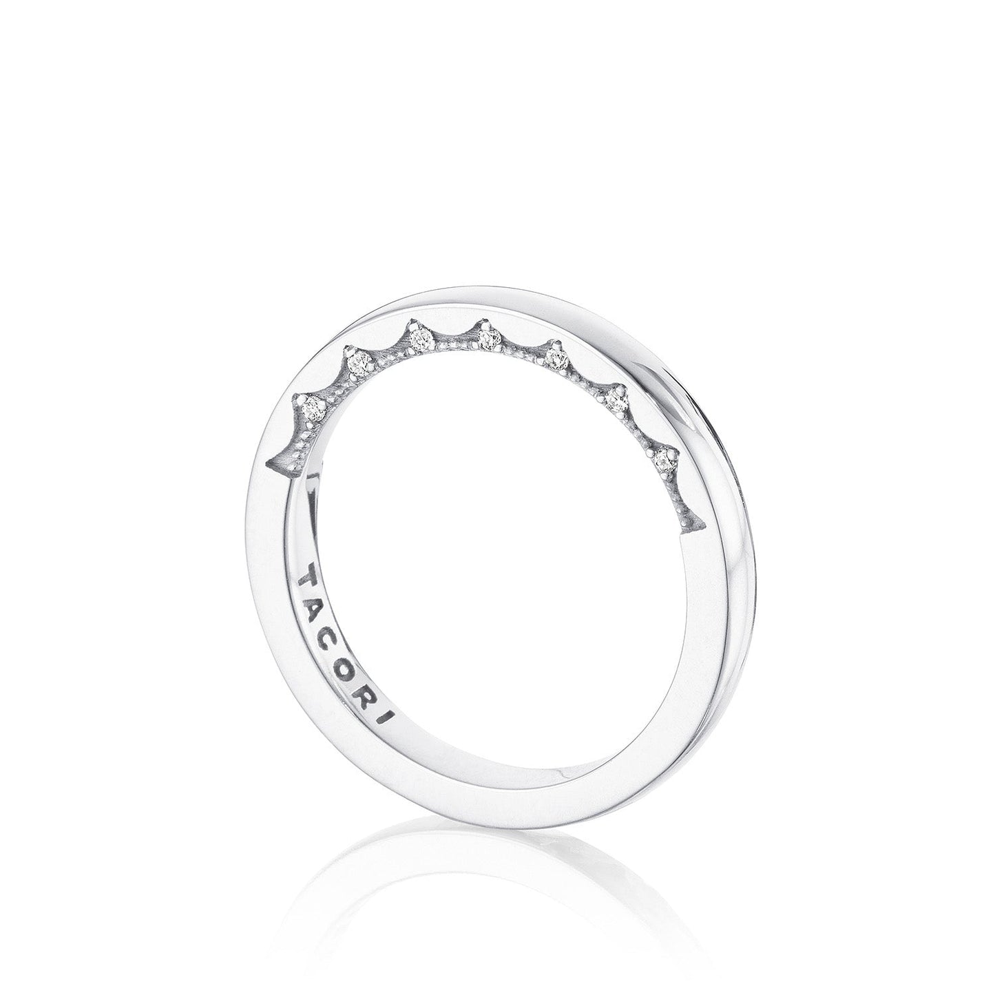 The Tacori Coastal Crescent High Polish Finish 14K White Gold Anniversary Ring with Diamond Accent embodies the elegance characteristic of TACORI wedding bands, featuring small sparkling diamonds set along one side. The interior of the band is engraved with "TACORI," showcasing a minimalist design that exudes timeless sophistication.